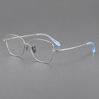 Soft square titanium glasses with angled upper corners and decorated hinges in Silver, three quarter view lens detail