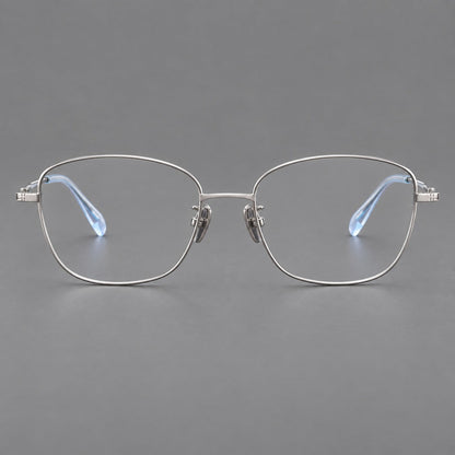 Soft square titanium glasses with angled upper corners and decorated hinges in Silver, front view temple detail