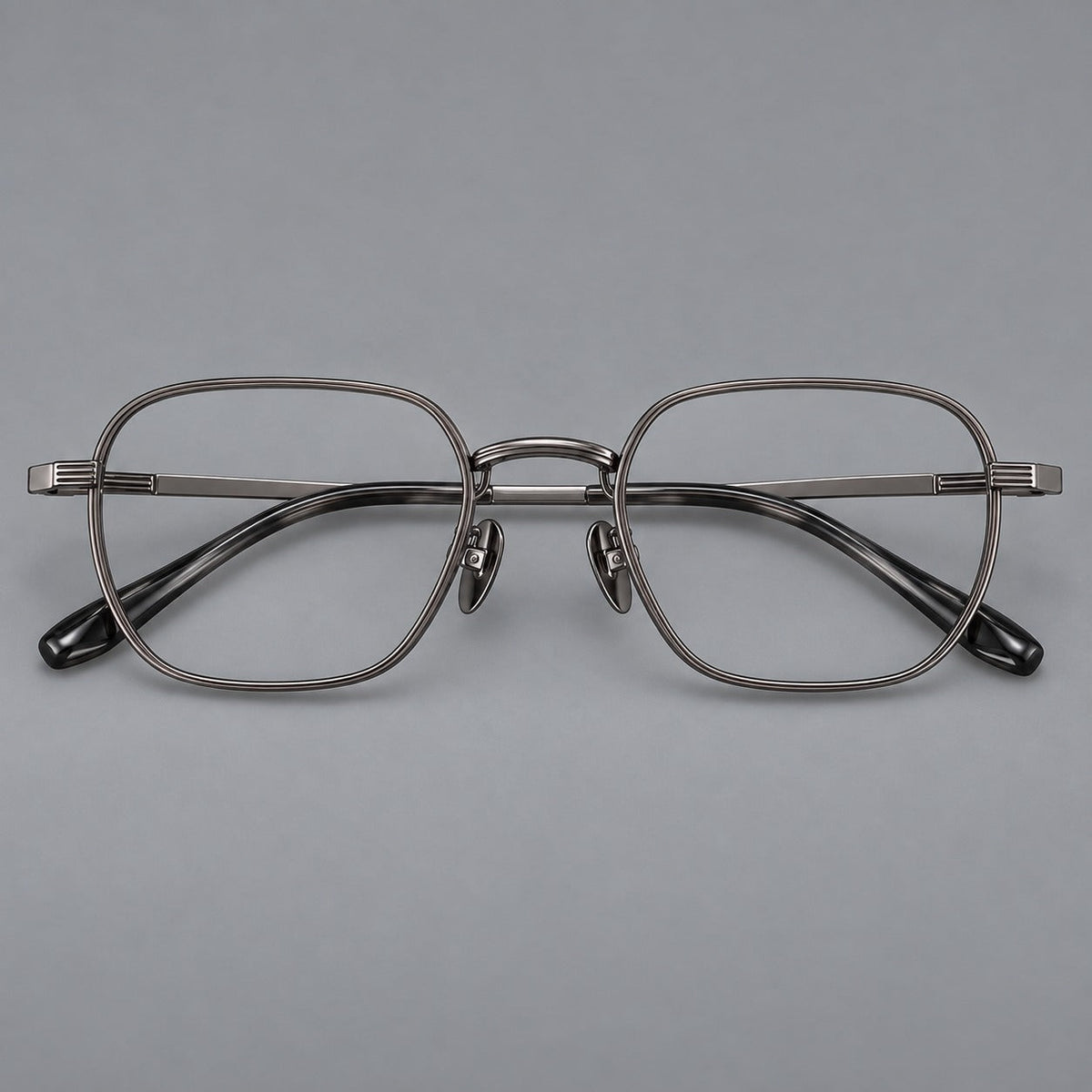 Retro square titanium glasses with rounded rims and finely grooved shoulders in Gunmetal, front view