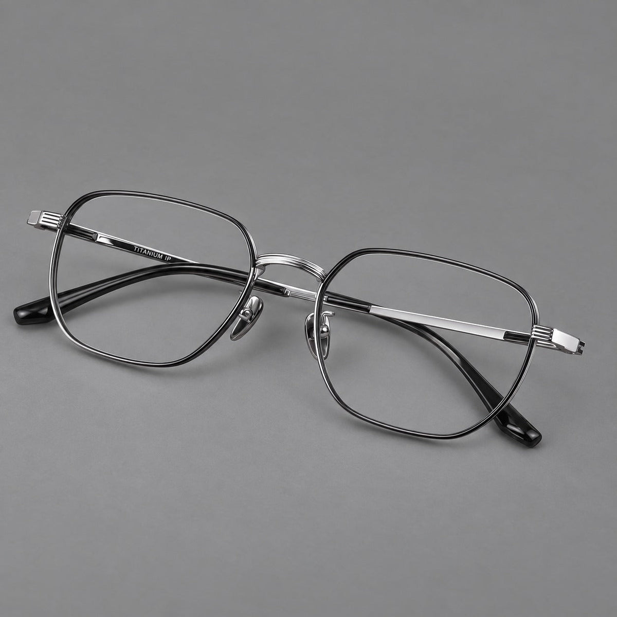 Retro square titanium glasses with rounded rims and finely grooved shoulders in Black and Silver, three quarter view