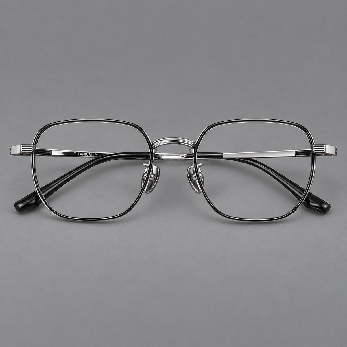 Retro square titanium glasses with rounded rims and finely grooved shoulders in Black and Silver, front view