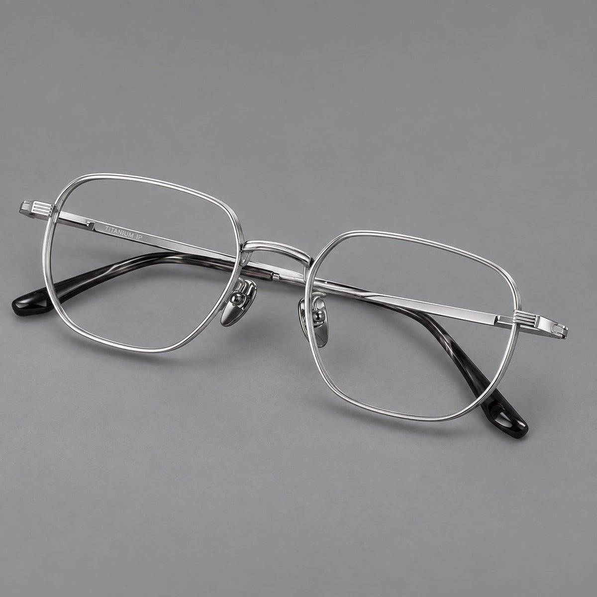 Retro square titanium glasses with rounded rims and finely grooved shoulders in Silver, three quarter view