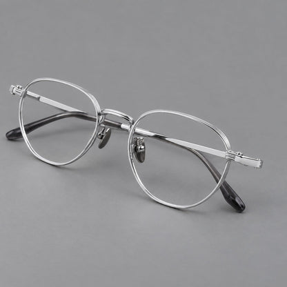 Retro panto titanium glasses with a curved bridge and fine parallel rim grooves in Silver, three quarter view lens detail