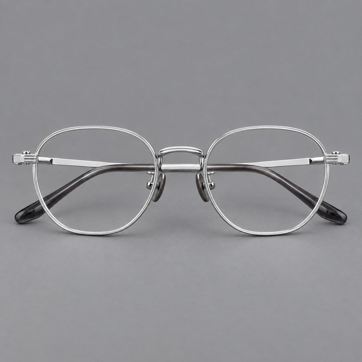 Retro panto titanium glasses with a curved bridge and fine parallel rim grooves in Silver, front view