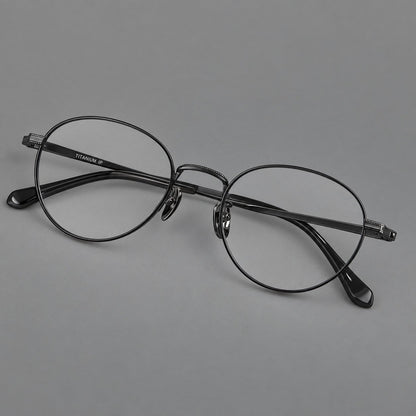 Rounded panto titanium glasses with a raised bridge and dotted temple accents in Black, three quarter view