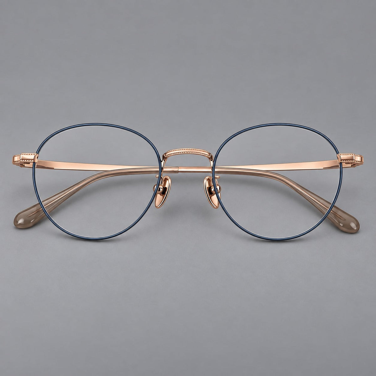Rounded panto titanium glasses with a raised bridge and dotted temple accents in Blue and Rose Gold, front view
