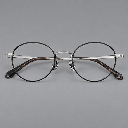Rounded panto titanium glasses with a raised bridge and dotted temple accents in Black and Silver, front view temple detail