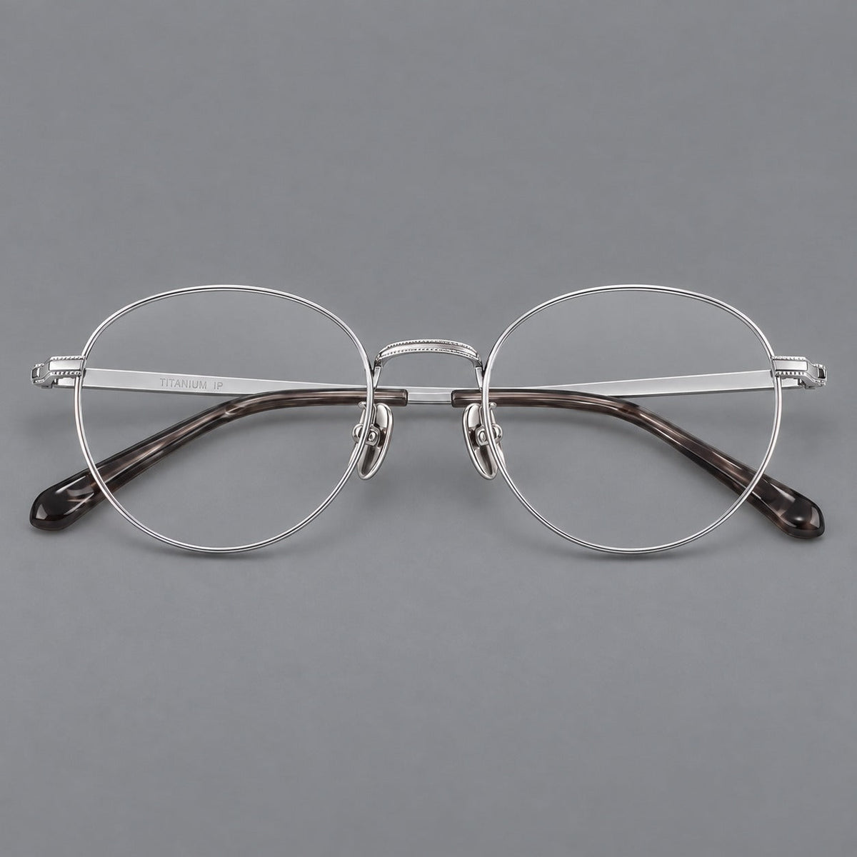 Rounded panto titanium glasses with a raised bridge and dotted temple accents in Silver, front view