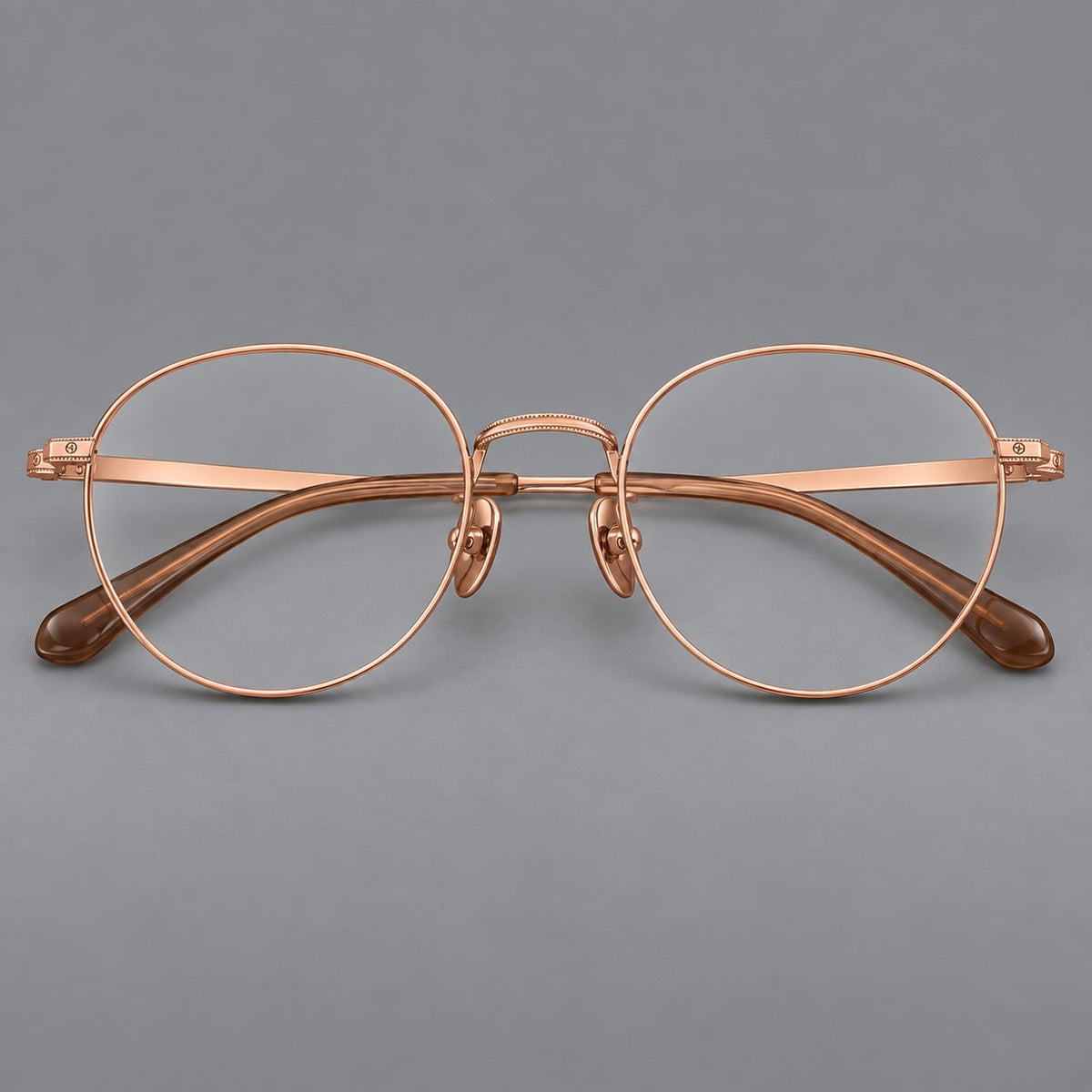 Rounded panto titanium glasses with a raised bridge and dotted temple accents in Rose Gold, front view