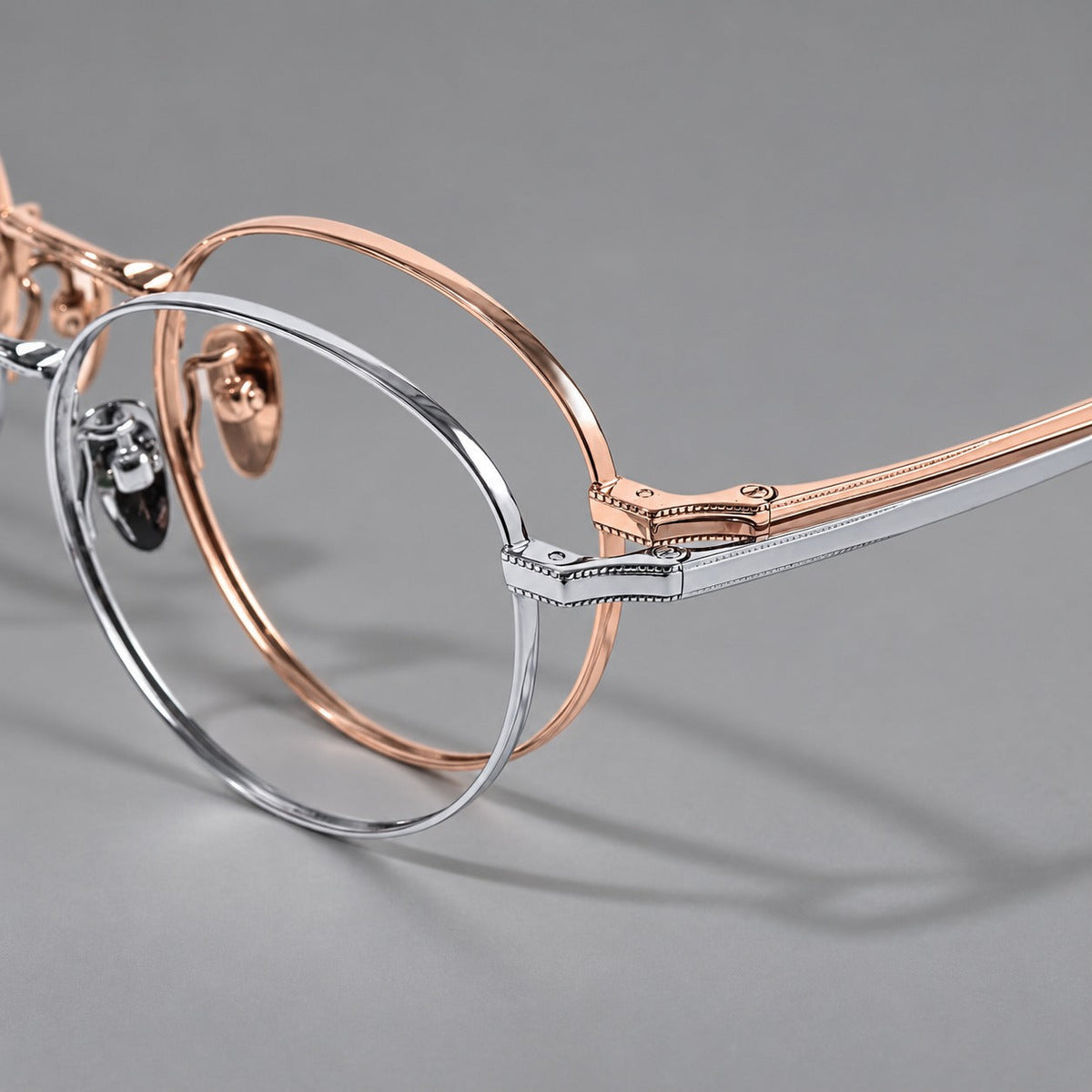 Rounded panto titanium glasses with a raised bridge and dotted temple accents, frame details