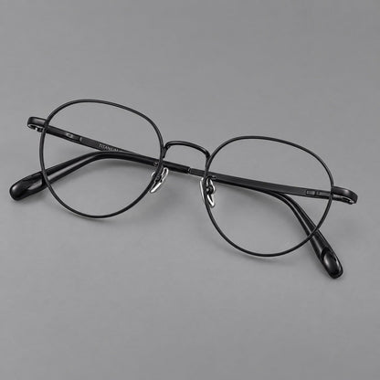 Classic round titanium glasses with broad flat temples and inset hinge details in Black, three quarter view