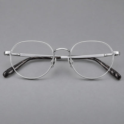 Classic round titanium glasses with broad flat temples and inset hinge details in Silver, front view temple detail