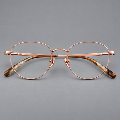 Classic round titanium glasses with broad flat temples and inset hinge details in Rose Gold, front view additional product view