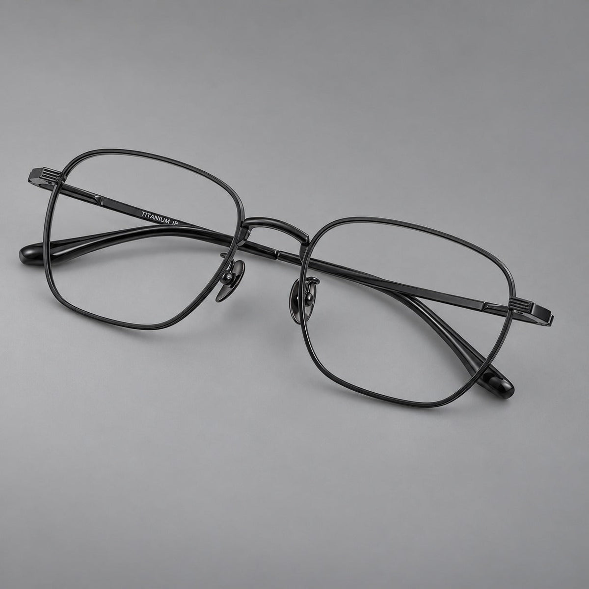 Deep square titanium glasses with a flatter brow and grooved outer shoulders in Black, three quarter view