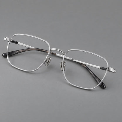 Deep square titanium glasses with a flatter brow and grooved outer shoulders in Black and Silver, three quarter view lens detail
