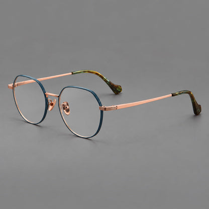 Geometric titanium glasses with soft polygonal rims and fine shoulder detailing in Blue and Rose Gold, three quarter view lens detail
