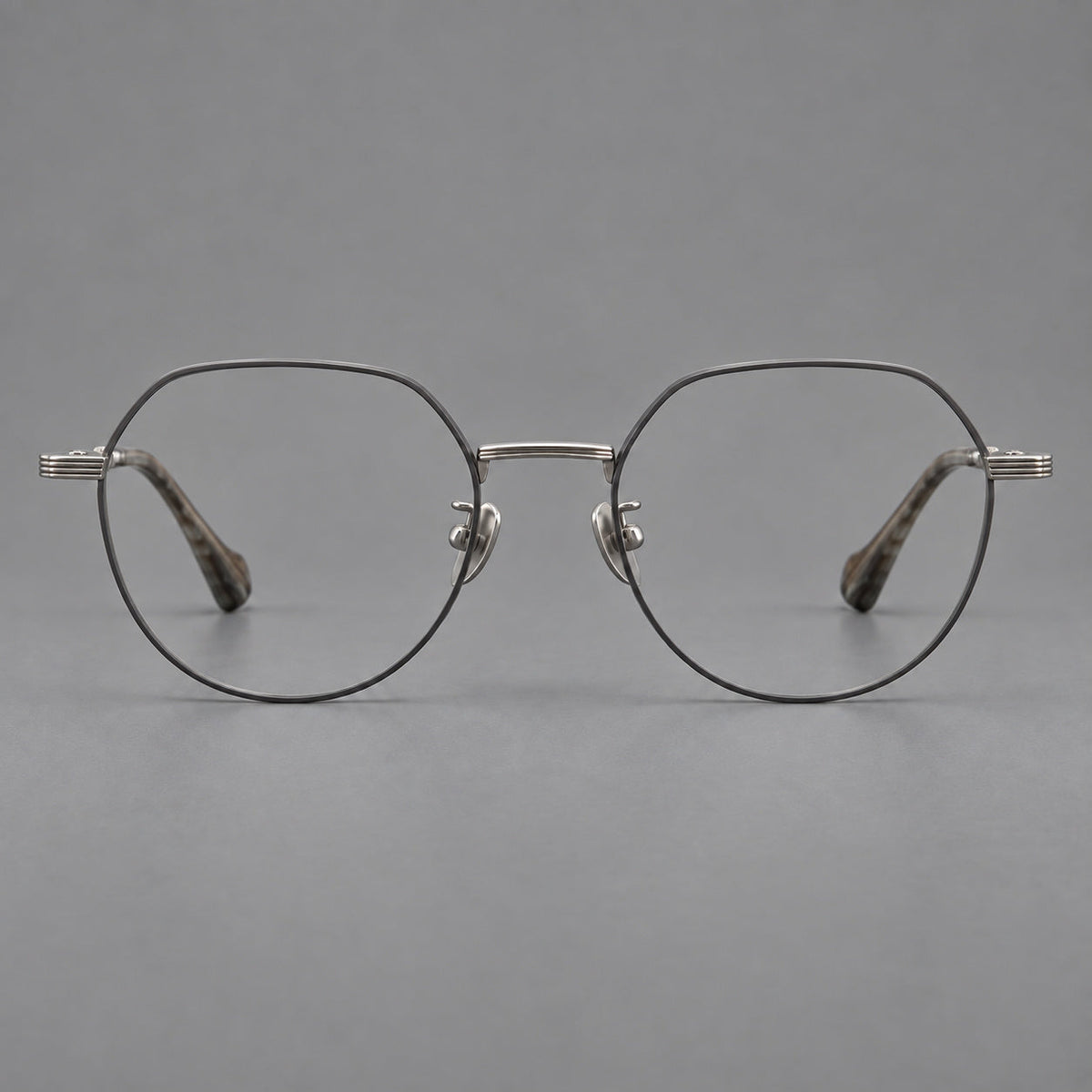 Geometric titanium glasses with soft polygonal rims and fine shoulder detailing in Gray and Silver, front view