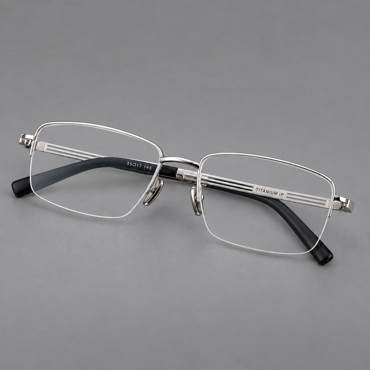 Classic half frame titanium glasses with rectangular lenses and lined temples in Silver, three quarter view