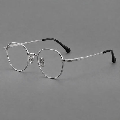 Compact round titanium glasses with an arched bridge and textured temple accents in Silver, three quarter view additional product view