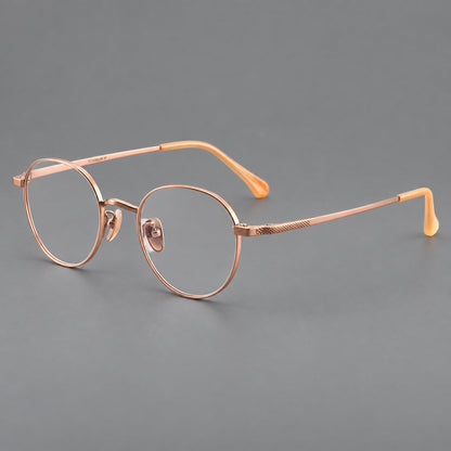 Compact round titanium glasses with an arched bridge and textured temple accents in Rose Gold, three quarter view additional product view