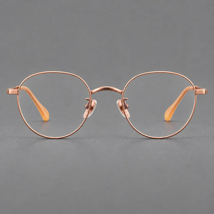 Compact round titanium glasses with an arched bridge and textured temple accents in Rose Gold, front view additional product view