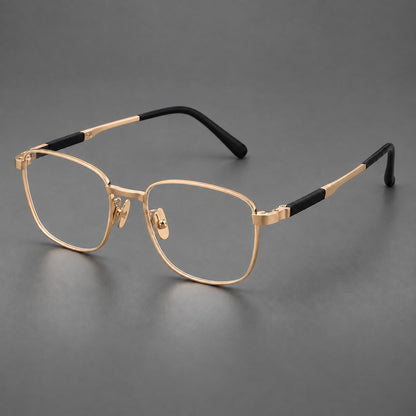 Slim rectangular titanium glasses with broad temples and contrasting dark inserts in Gold, three quarter view lens detail