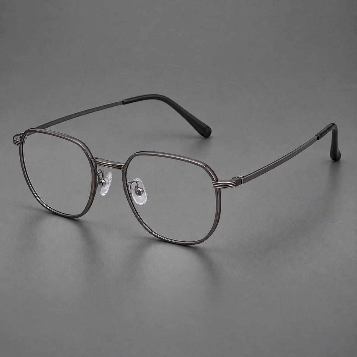 Geometric titanium glasses with flattened corners and a finely ridged bridge in Dark Gray, three quarter view