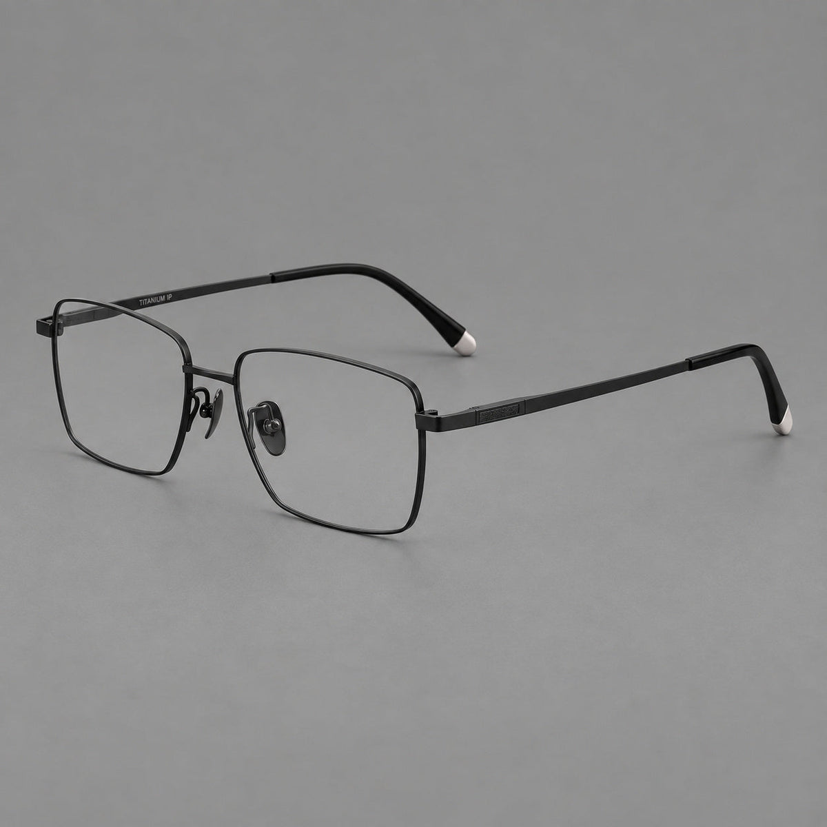 Clean rectangular titanium glasses with inset temple details and pale end accents in Black, three quarter view