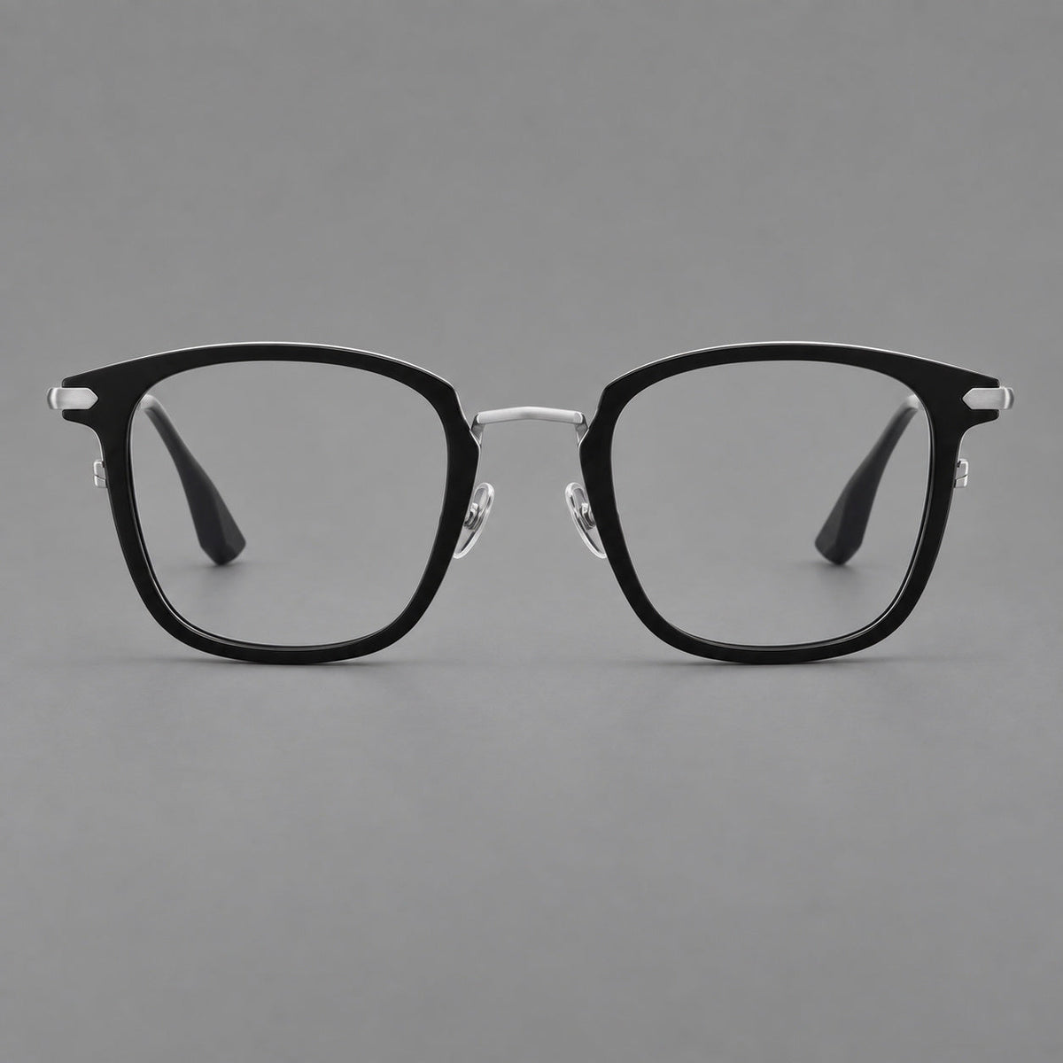 Bold square titanium glasses with a separate bridge and long metal corner accents in Black and Silver, front view