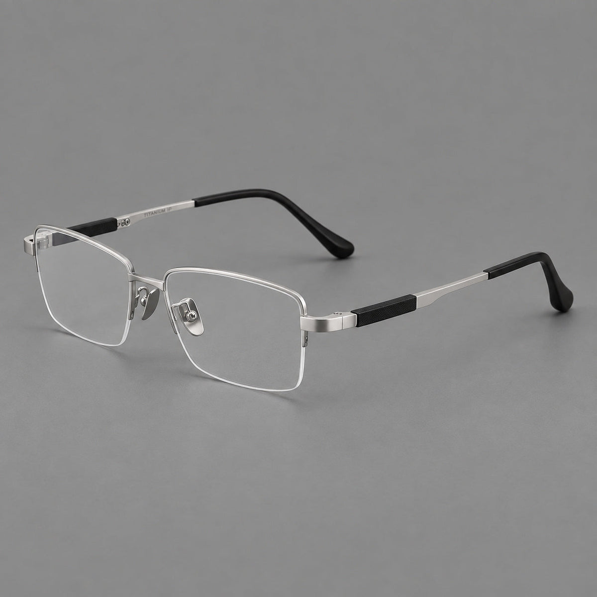 Modern half frame titanium glasses with a narrow bridge and dark temple sections in Silver, three quarter view