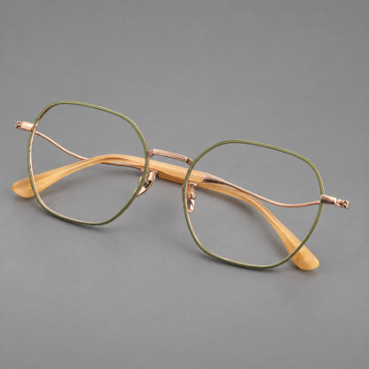 Geometric titanium glasses with engraved rim edges and curved temple joins in Green and Rose Gold, three quarter view lens detail