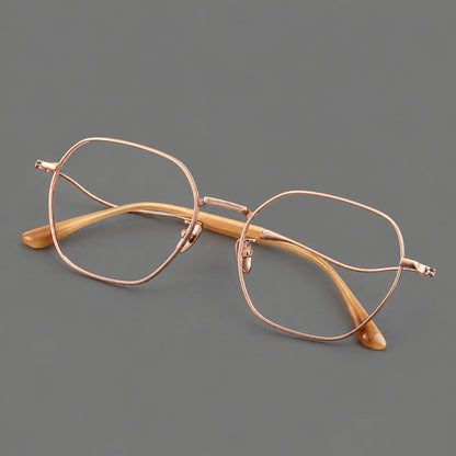Geometric titanium glasses with engraved rim edges and curved temple joins in Rose Gold, three quarter view additional product view