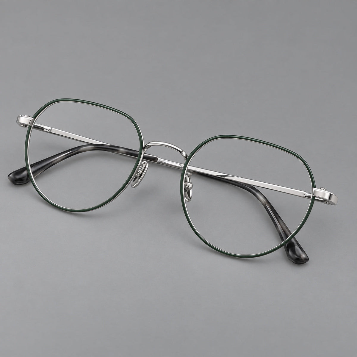 Classic panto titanium glasses with a curved bridge and slim straight temples in Dark Green and Silver, three quarter view