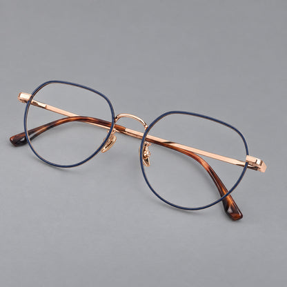 Classic panto titanium glasses with a curved bridge and slim straight temples in Blue and Rose Gold, three quarter view lens detail