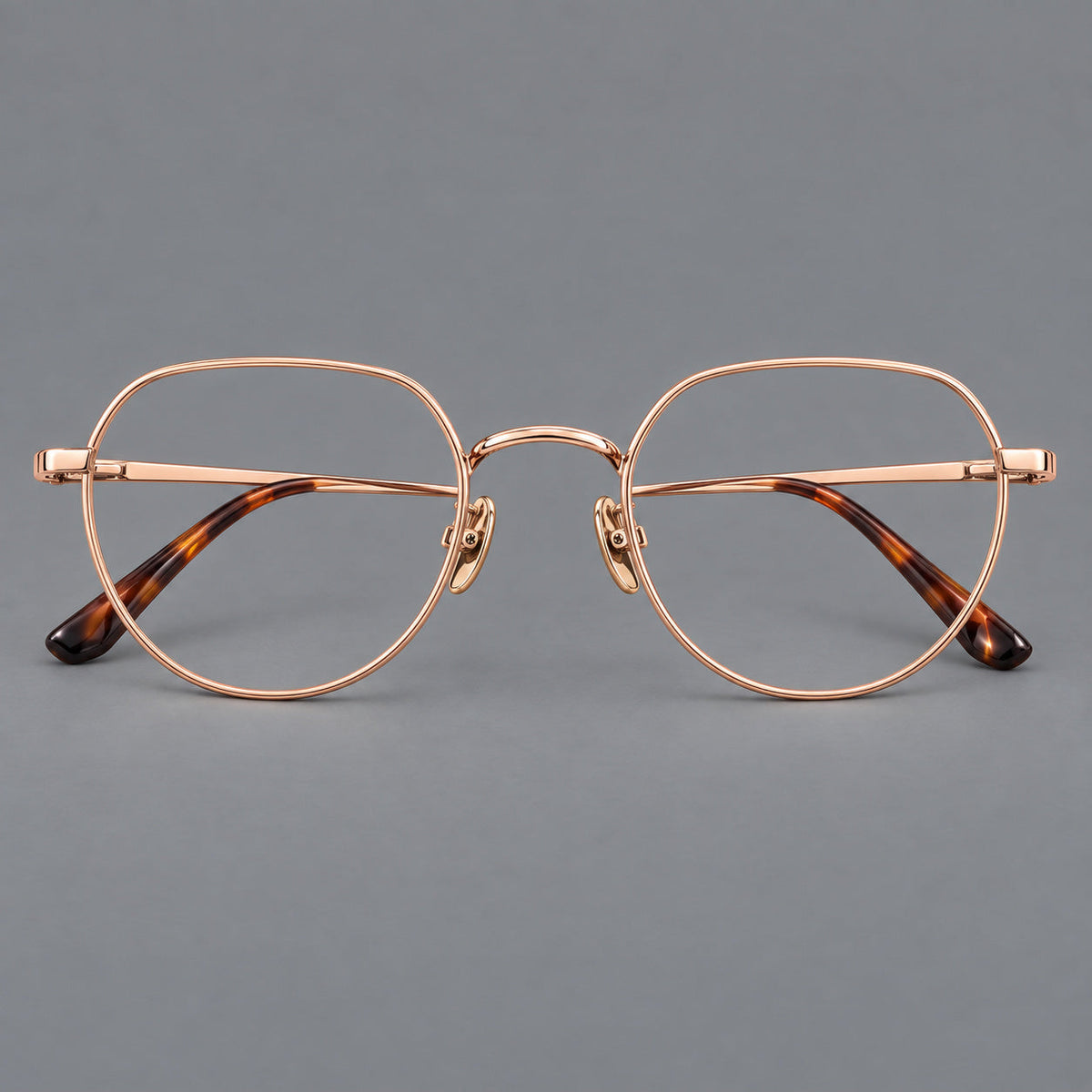 Classic panto titanium glasses with a curved bridge and slim straight temples in Rose Gold, front view