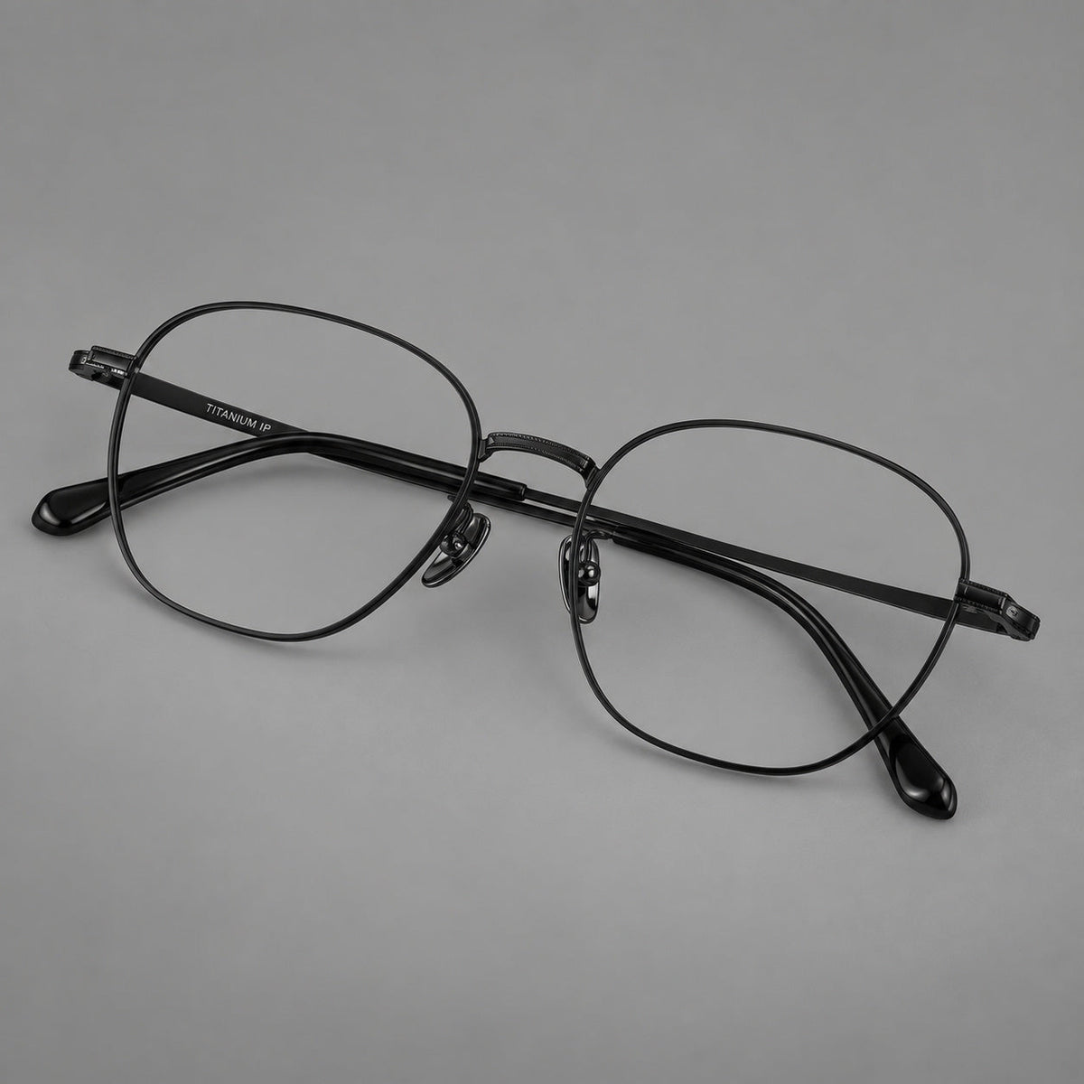 Retro panto titanium glasses with stepped corners and finely engraved temples in Black, three quarter view