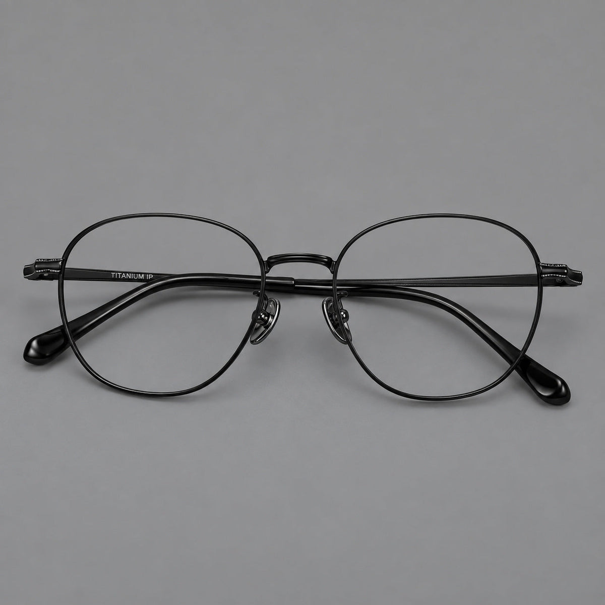 Retro panto titanium glasses with stepped corners and finely engraved temples in Black, front view