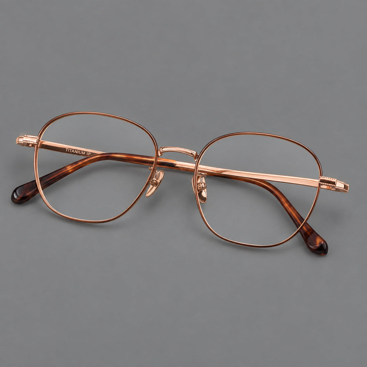 Retro panto titanium glasses with stepped corners and finely engraved temples in Brown and Rose Gold, three quarter view