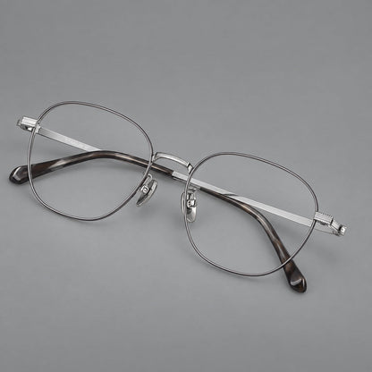 Retro panto titanium glasses with stepped corners and finely engraved temples in Gray and Silver, three quarter view lens detail