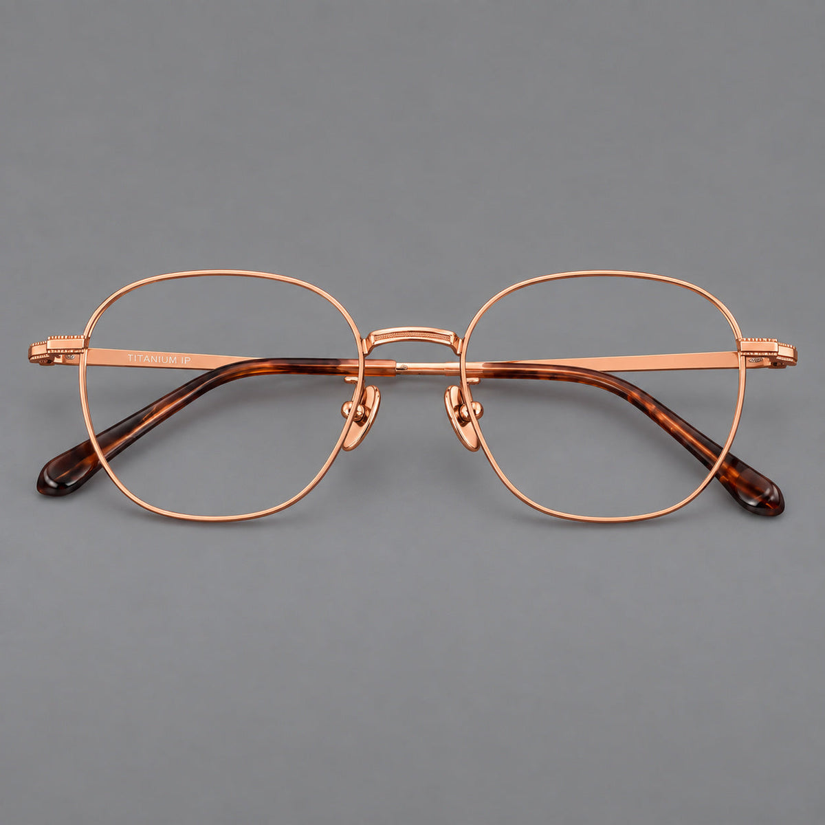 Retro panto titanium glasses with stepped corners and finely engraved temples in Rose Gold, front view