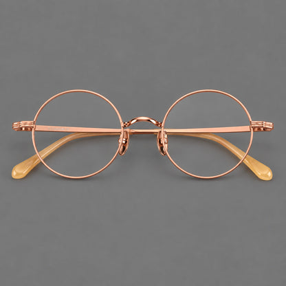 Compact circular titanium glasses with a curved bridge and wavy engraved temples in Rose Gold, front view additional product view