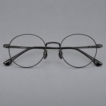 Classic circular titanium glasses with a raised bridge and lined temple accents in Black, front view side view