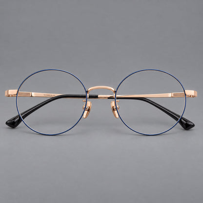 Classic circular titanium glasses with a raised bridge and lined temple accents in Blue and Gold, front view frame detail