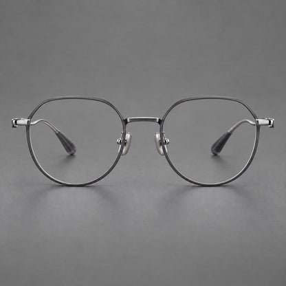 Rounded titanium glasses with a short bridge and distinctive wavy metal temples in Matte Gray and Silver, front view frame detail