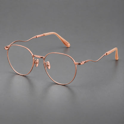 Rounded titanium glasses with a short bridge and distinctive wavy metal temples in Rose Gold, three quarter view additional product view