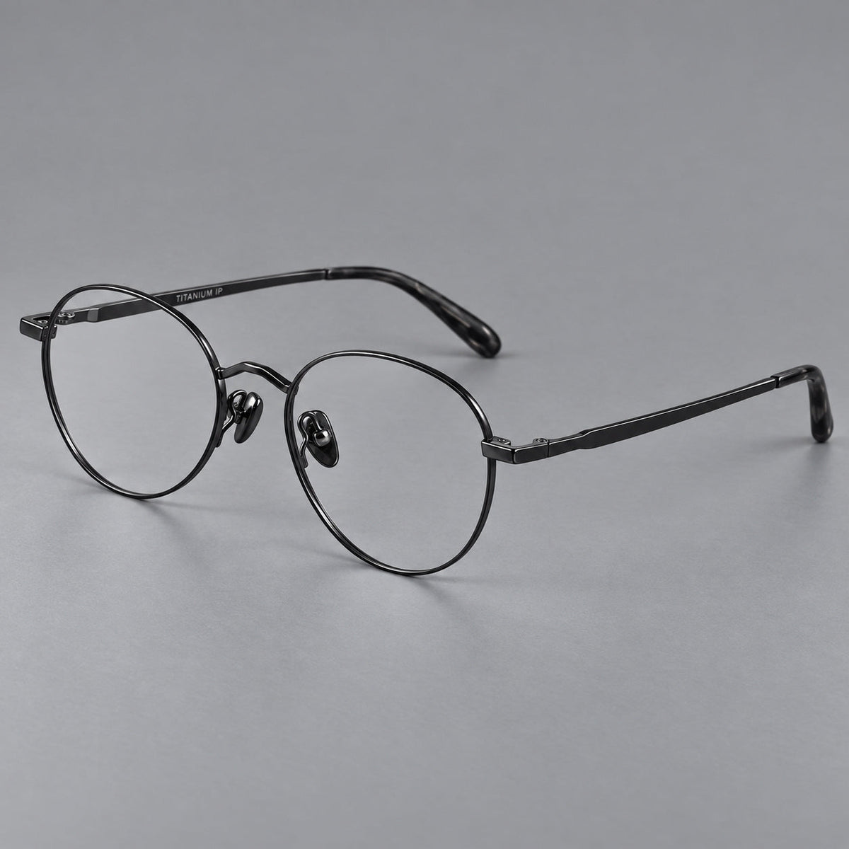 Retro panto titanium glasses with faceted corners and mottled curved temple tips in Black, three quarter view