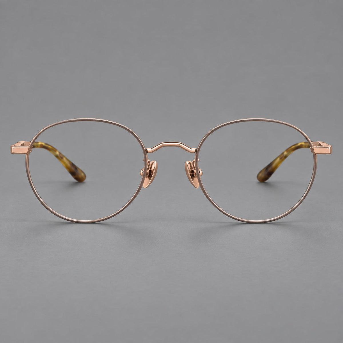 Retro panto titanium glasses with faceted corners and mottled curved temple tips in Gray Brown and Rose Gold, front view