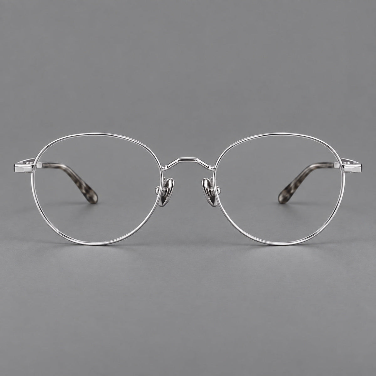 Retro panto titanium glasses with faceted corners and mottled curved temple tips in Silver, front view