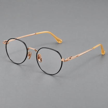 Small panto titanium glasses with an angular bridge and recessed temple details in Black and Rose Gold, three quarter view front view