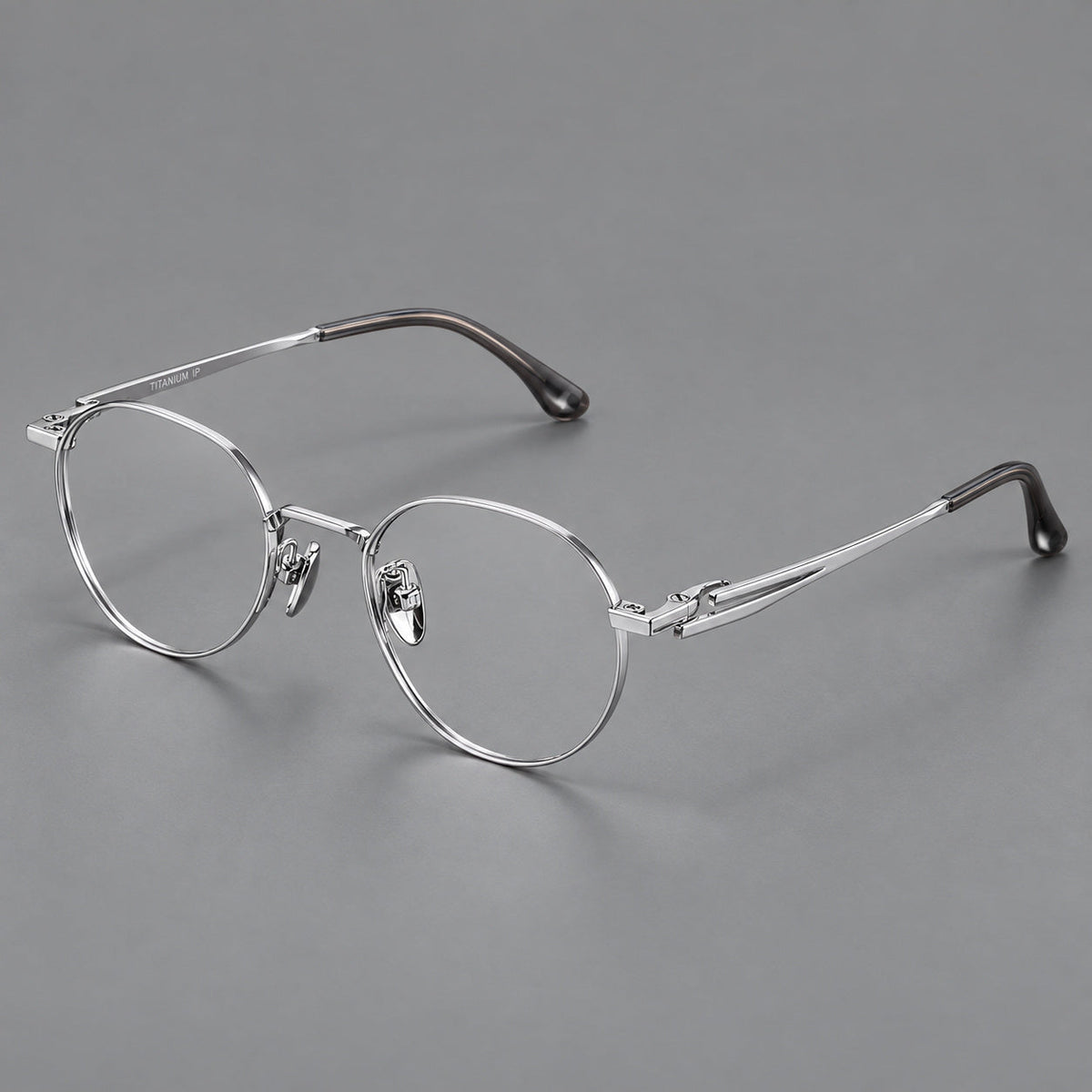 Small panto titanium glasses with an angular bridge and recessed temple details in Silver, three quarter view